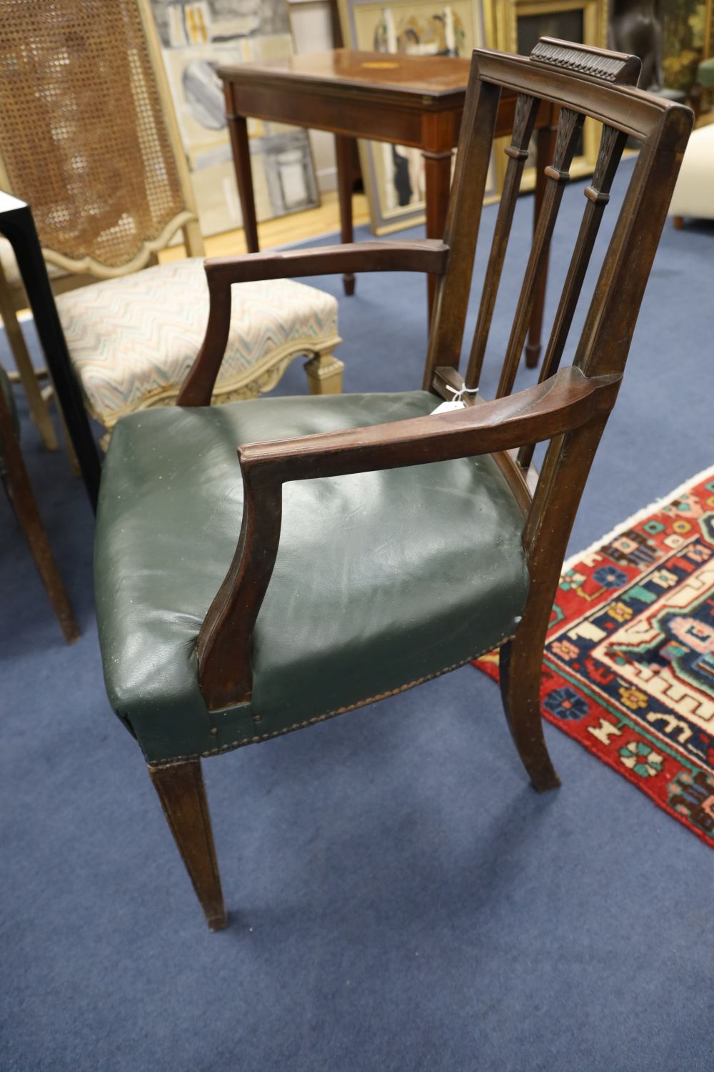 A set of six Hepplewhite style mahogany chairs (two with arms)